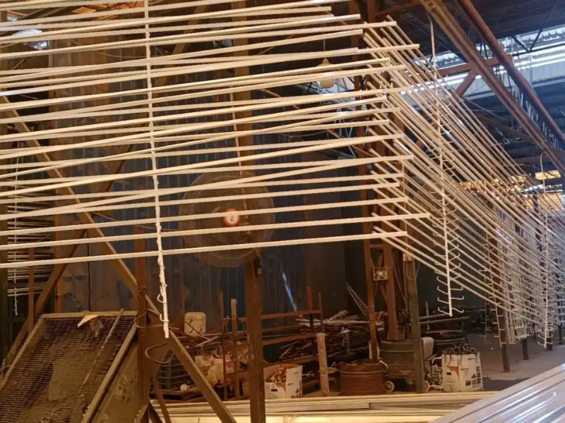 Real shot of China professional aluminum profile powder coating workshop, hanging finished powder coated architectural aluminum window and door profiles after electrostatic spraying, full-automatic production line for building aluminum extrusions