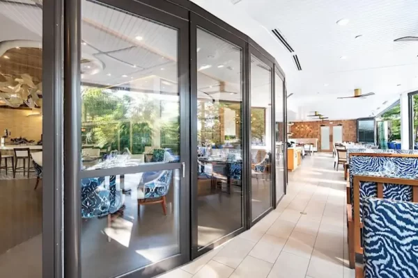Heavy-duty commercial aluminum folding doors installed in a high-end restaurant dining area.